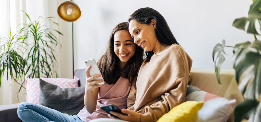 Maman et adolescente qui regardent un téléphone